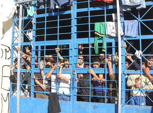 A group of young detainees stare at visitors to the crowded centre at Pagani. © UNHCR/L.Boldrini