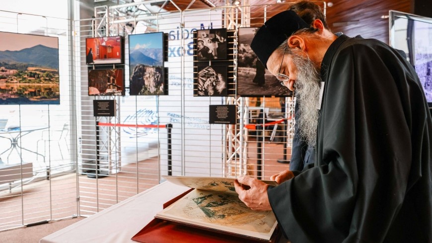 An Orthodox priest from Mount Athos looks at a copy of Ptolomey’s Geography