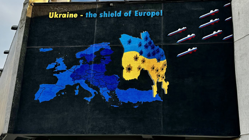 A billboard at the entrance of the National Museum of the History of Ukraine in World War II depicts Ukraine as the shield of Europe against Russian aggression. The unseen side of the shield could be the devastating effects of the misuse of history by the Russian Federation — in this case, to justify war. Today, reaffirming the crucial role of history education in democracies, and the need for its alignment with European values of human rights, dignity, and democracy, has become more important than ever.