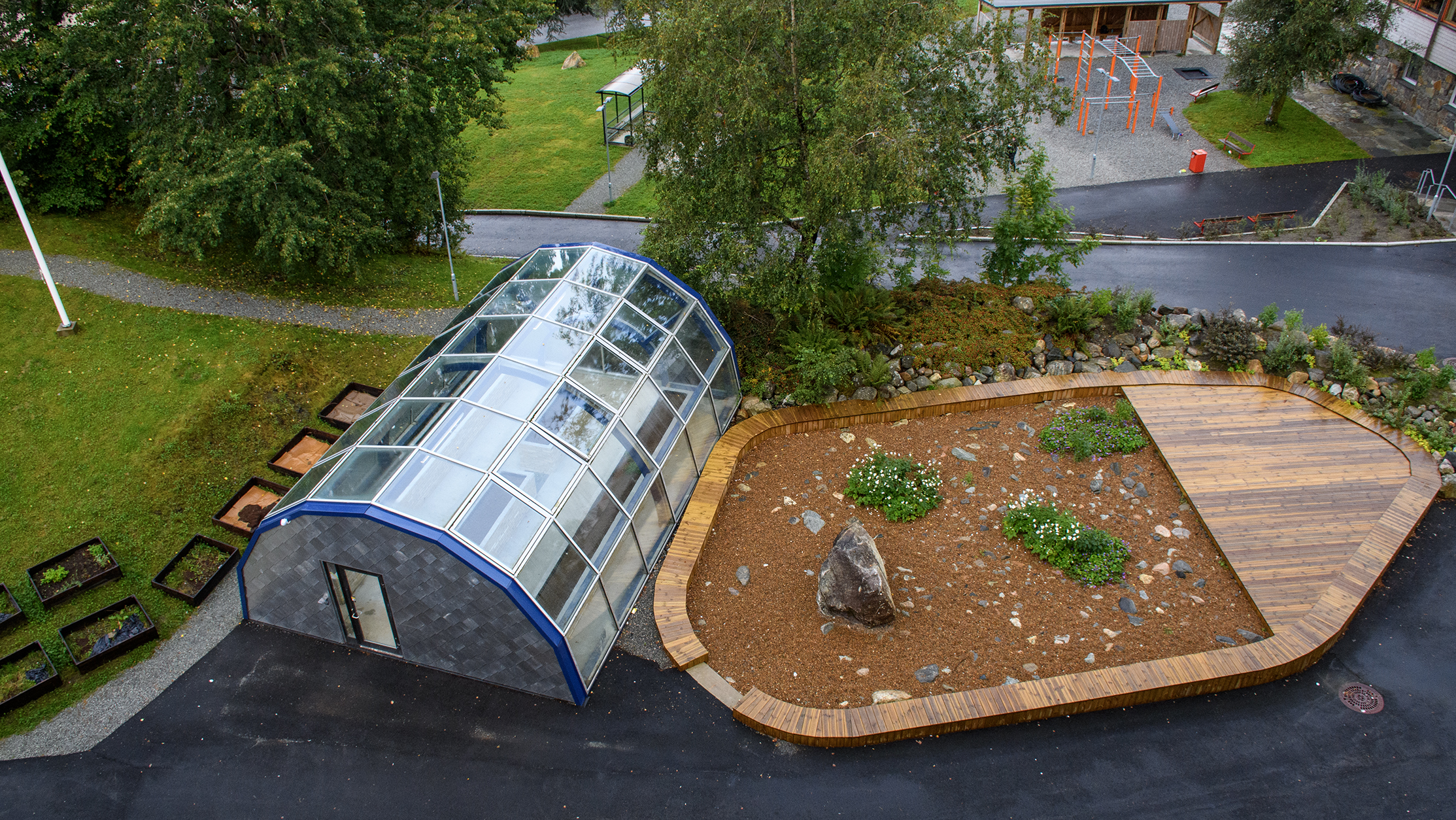 La photo montre une serre avec un potager et des installations sportives. Crédits : Andrew M.S. Buller