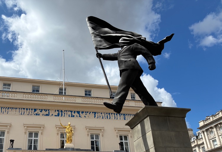 Figure 1: A Banksy statue and the goddess Athena “seeing” differently in Waterloo Place, London, 30 July 2026 (c) Arthur Chapman